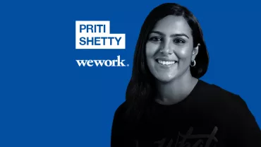 Smiling person in a business-themed graphic with WeWork logo.